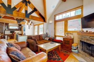 a living room with leather furniture and a fireplace at Quittin' Time on the Woodside in Park City