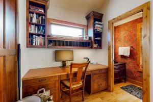 a home office with a wooden desk and a chair at Quittin' Time on the Woodside in Park City