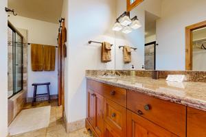 a bathroom with a double sink and a large mirror at Quittin' Time on the Woodside in Park City +18 photos