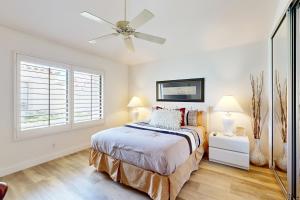 a bedroom with a bed and a ceiling fan at Riviera Manor Permit# 68147 in La Quinta