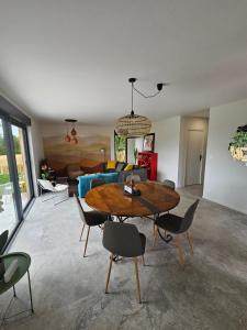 a living room with a table and chairs and a couch at Villa Gwin Zegal in Plouha