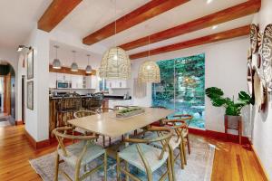 a kitchen and dining room with a wooden table and chairs at Heartwood Manor in Asheville