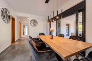 a dining room with a wooden table and leather chairs at Apartments Royal in Vir +53 photos