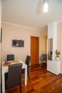a dining room with a white table and chairs at Tisa & Neo in Rijeka +4 photos