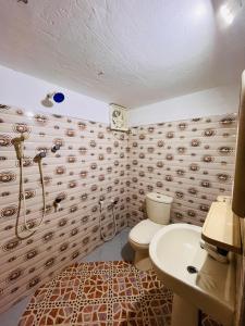 a bathroom with a toilet and a sink at Early birds in Arugam Bay +55 photos