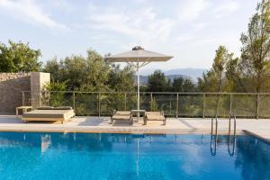 a swimming pool with chairs and an umbrella at Anassia Villas in Nafplio +33 photos