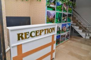 a reception desk in a building with a sign that reads reception at ST Apart in Pelitli
