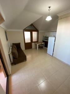 a living room with a couch and a refrigerator at ST Apart in Pelitli