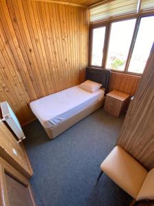 a small bedroom with a bed in a wooden room at ST Apart in Pelitli +17 photos