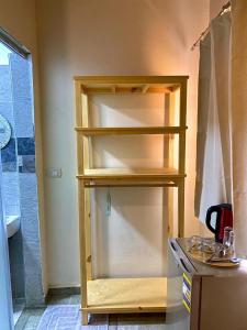 a wooden shelf in a kitchen with a shower at Balance Lodges in Dahab +18 photos