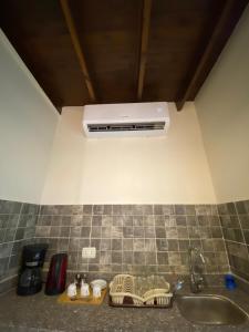 a kitchen counter with a sink and a vent at Balance Lodges in Dahab