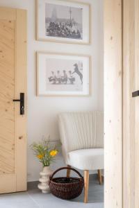 a living room with a chair and a picture on the wall at MiLove in Milówka