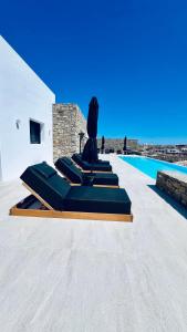 a villa with a pool and a statue next to it at Villa Taiyo Mykonos in Mikonos