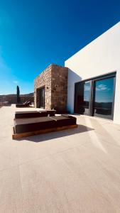 a bedroom with two beds in a building at Villa Taiyo Mykonos in Mikonos +70 photos