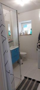 a bathroom with a mirror and a blue cabinet at blu dragonfly in Saint-Aubin-sur-Loire +2 photos