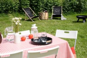 a picnic table with a red and white checkered table cloth at MiLove in Milówka