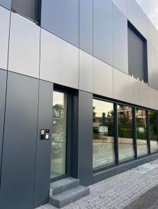 a facade of a building with glass windows at AR TAHITI black in Košice