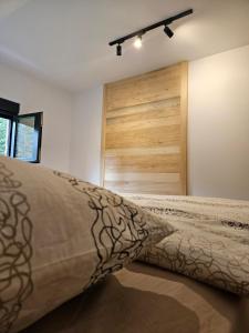 a bedroom with a bed and a wooden door at Forest Fox in Žabljak