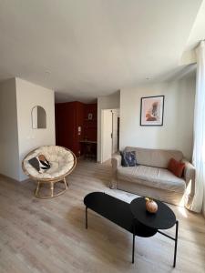 a living room with a couch and a table at Appartement Champollion 2 in Figeac
