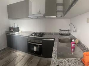 a kitchen with a sink and a counter top at BB immo dakar in Dakar +12 photos