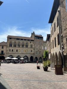 a large building with a courtyard in front of it at Appartement Champollion 2 in Figeac