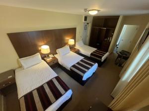 Voodi või voodid majutusasutuse Cryans Hotel toas
