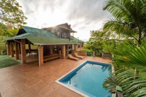 a house with a swimming pool in front of it at Recanto Vera Lucia in Santo Amaro da Imperatriz