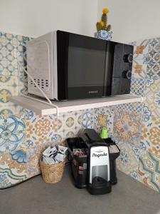 a microwave sitting on a shelf on a wall at SummaMontis - Sommatino in Sommatino +23 photos