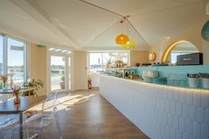 a kitchen with a counter and a table and chairs at Hôtel Océan in Capbreton