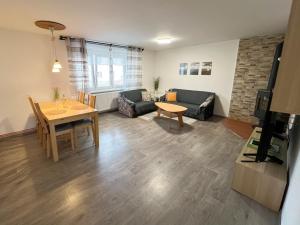 a living room with a couch and a table at Apartmán U Jiroutů in Rokytnice v Orlických Horách
