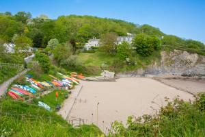 a beach with a bunch of umbrellas on it at Y Geraint Beach Apartment Aberporth in Aberporth +7 photos