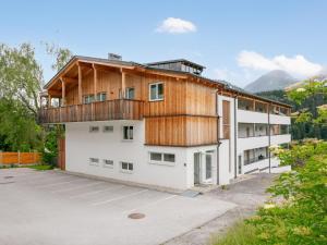 a house with a balcony on top of a parking lot at Apart33 Top 2-13 in Haus im Ennstal