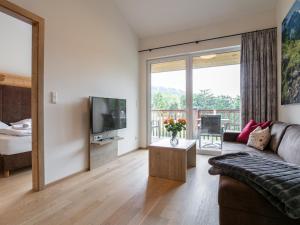 a living room with a couch and a tv at Apart33 Top 2-13 in Haus im Ennstal