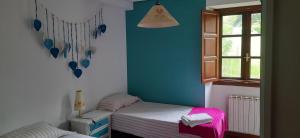a small bedroom with a bed and a window at La Sierra del Aguanaz in Entrambasaguas