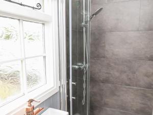 a shower with a glass door in a bathroom at Lady Bird Retreat in Saltburn-by-the-Sea