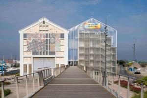 two glass buildings on a boardwalk at La Maison Bleue, Jardin & Mer 300m in Dunkerque