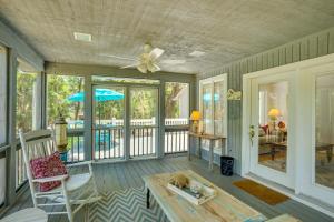 a living room with a ceiling fan and a table at Near Edisto Beach State Park Home with Lanais! in Edisto Island