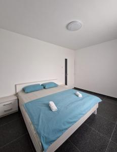 a bedroom with a large bed with blue sheets and pillows at Villa AS in Bihać +37 photos