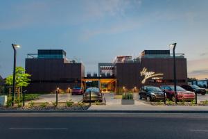 a parking lot with cars parked in front of a building at Hygge Hotel in Opole