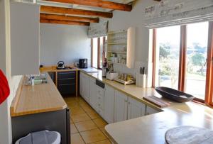 a large kitchen with a counter and a counter top at Riverview in Stilbaai