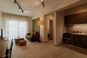 a large living room with a couch and a kitchen at Dantis Place Alpha1 in Nafplio