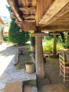 a wooden pergola with a bucket under it at Somiedoeco in Caunedo +18 photos