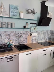 a kitchen with a sink and a counter top at Chillout na Wspólnej in Kluki