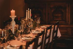 a long table with candles and wine glasses on it at Mountain retreat in the Pyrénées, glorious views, fire pit & pool - Sleeps 14 in Ossun-ez-Angles +29 photos