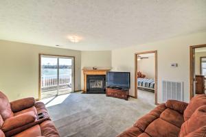 a living room with two couches and a television at Waterfront Montross Home with Private Boat Slip! in Montross