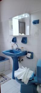 a bathroom with a blue sink and a mirror at Villa Makris in Zenempisátika