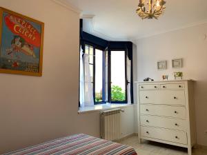 a bedroom with a bed and a dresser and a window at El Pinedo AZUL 3 dormitorios in Noja +24 photos