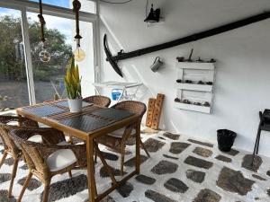 a dining room with a wooden table and chairs at Casa Vereda del Risco in Ye