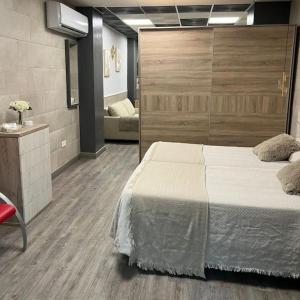 a bedroom with a large bed and a couch at Guadiana Loft Experience Nadra in Badajoz