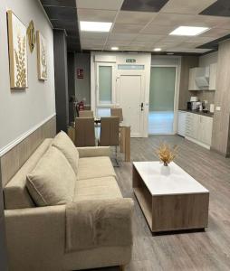 a living room with a couch and a coffee table at Guadiana Loft Experience Nadra in Badajoz +8 photos